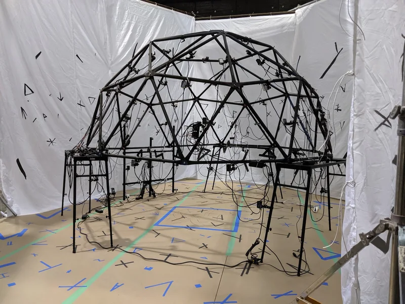 Portable geodesic camera dome against tracking backdrop; alternate angle.