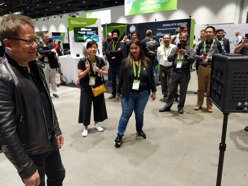 Jensen Huang watching the VCS camera demonstration with attendees.
