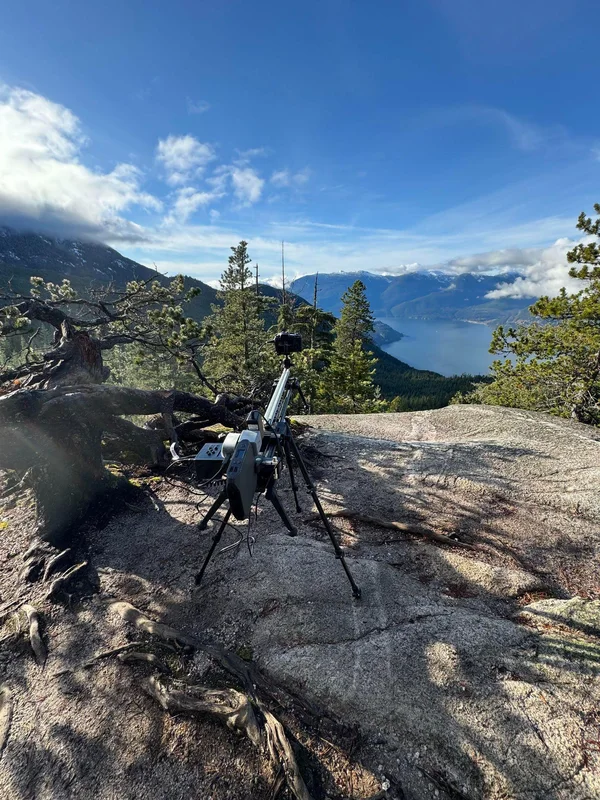 Camera on a slider overlooking mountains and water.