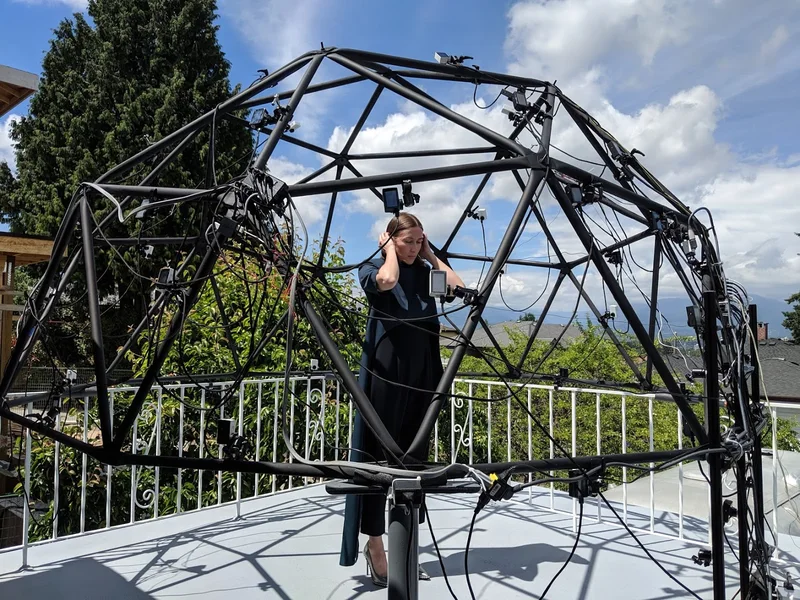 Balcony dome rig with performer in black.
