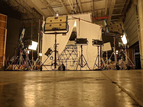 Wide lighting setup around camera rig on studio floor.