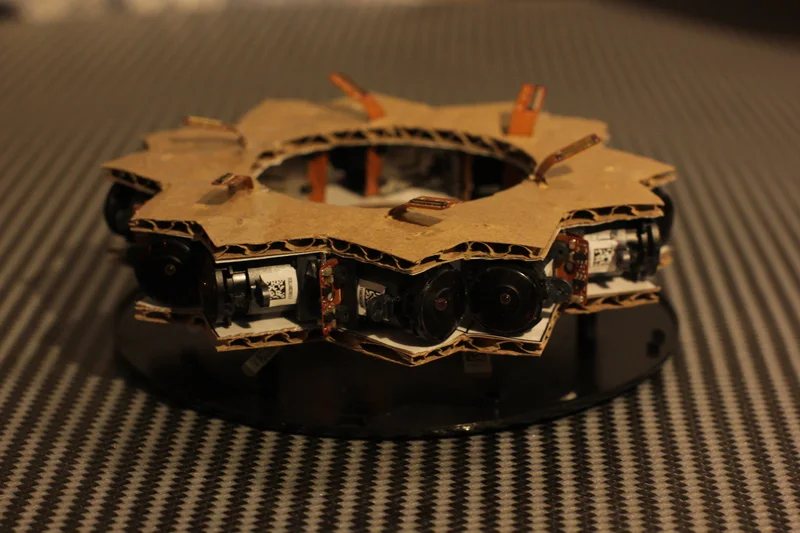 Completed compact stereo multi-camera ring prototype on textured tabletop.