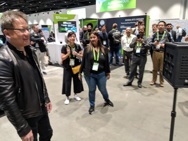 Jensen Huang and attendees at the compact-camera demo.