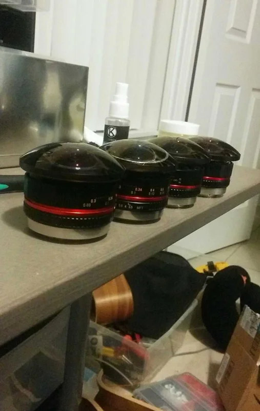 Custom fisheye lens prototypes laid out on shelf.