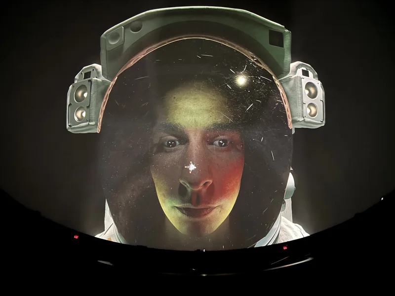 Dome theatre displaying astronaut helmet footage.
