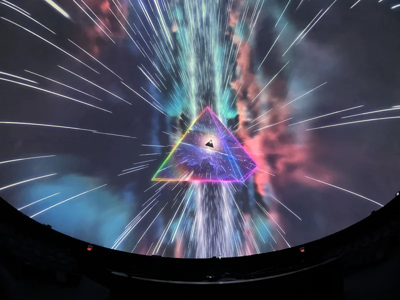 Dome theatre displaying colorful Pink Floyd projected art.