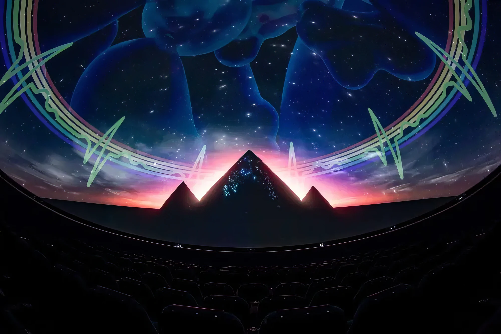 Wide Dome theatre photograph with pyramids/celestial Pink Floyd projection and seats.