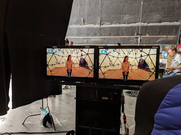 Witness monitors showing performer inside capture rig.