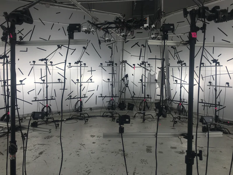 Bright wide stage view showing camera poles, tracked walls and ceiling rig.