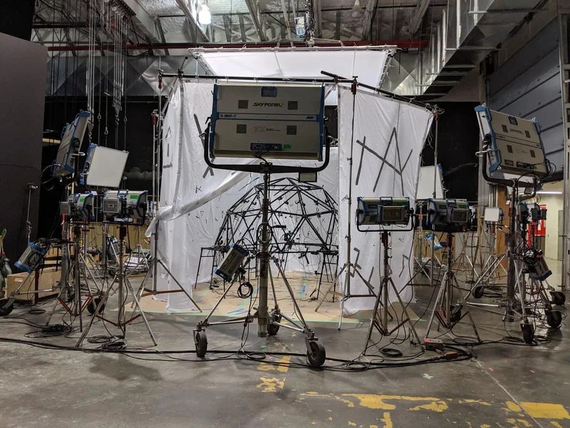 Studio capture dome with lighting panels and tracked surfaces.