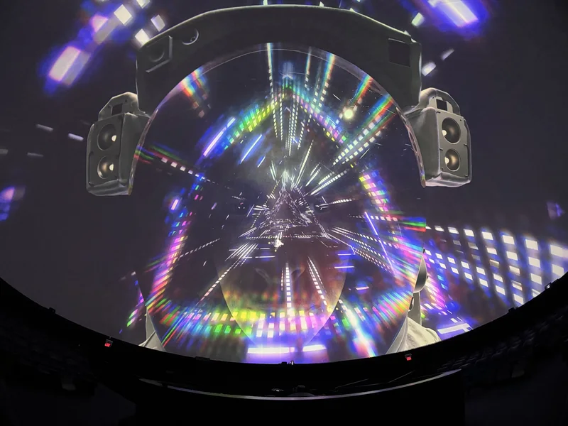 Dome theatre displaying colorful Pink Floyd projected art.