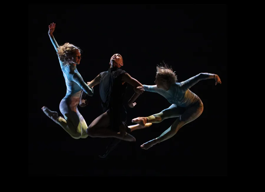 Three dancers in a leap during The Pearl Diver’s Daughter.