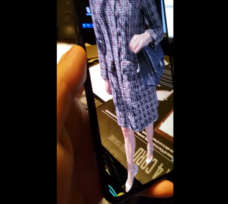 Captured fashion performance displayed on a handheld device.