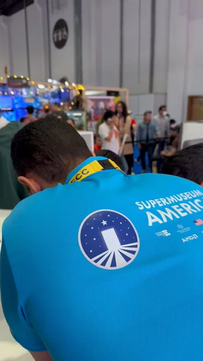 SuperMuseum exhibition team at ComicCon — frame from the VCS launch video.