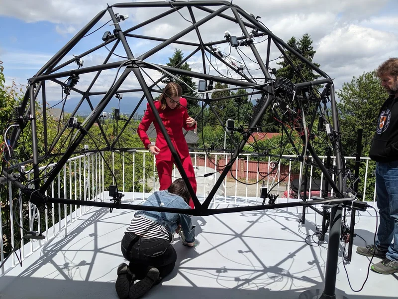 Balcony dome capture rig with performer in red.