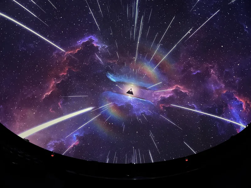 Dome theatre displaying colorful Pink Floyd projected art.