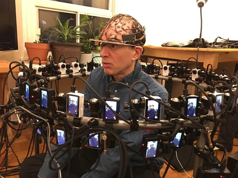 Close camera ring capturing seated performer wearing tracking cap.