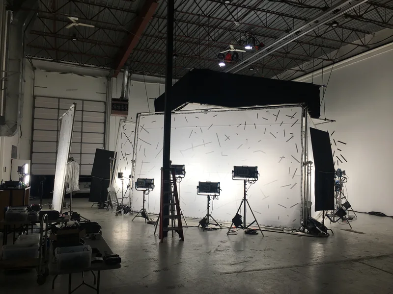 Wide warehouse installation with lit tracking backdrop and capture hardware.