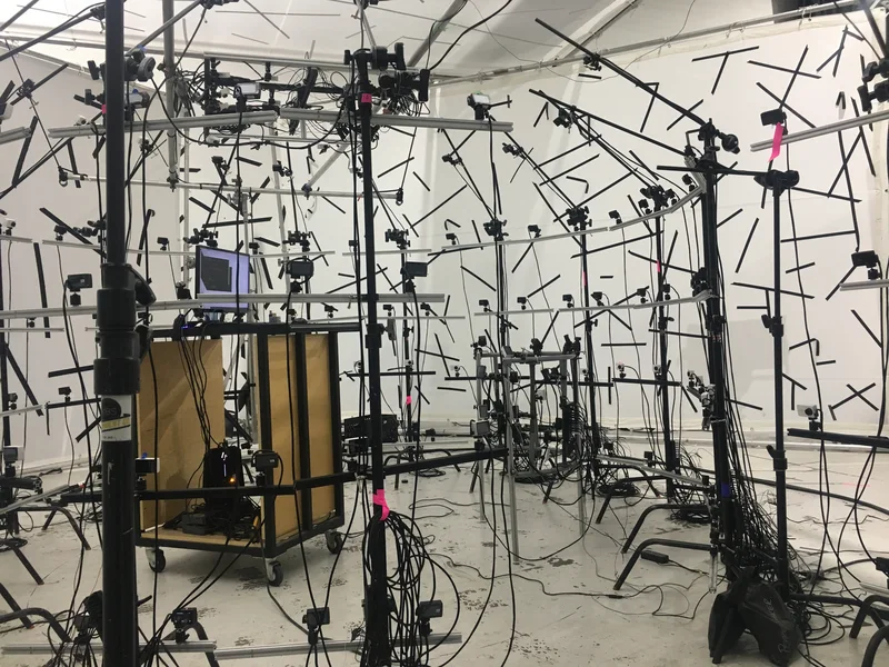 Camera stage with witness monitor cart, tripod grid and ceiling supports.