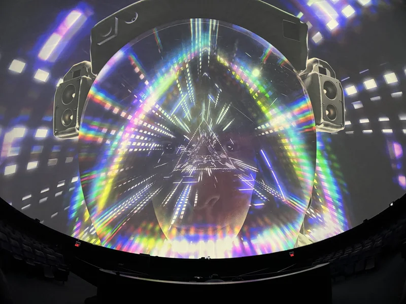 Dome theatre displaying colorful Pink Floyd projected art.