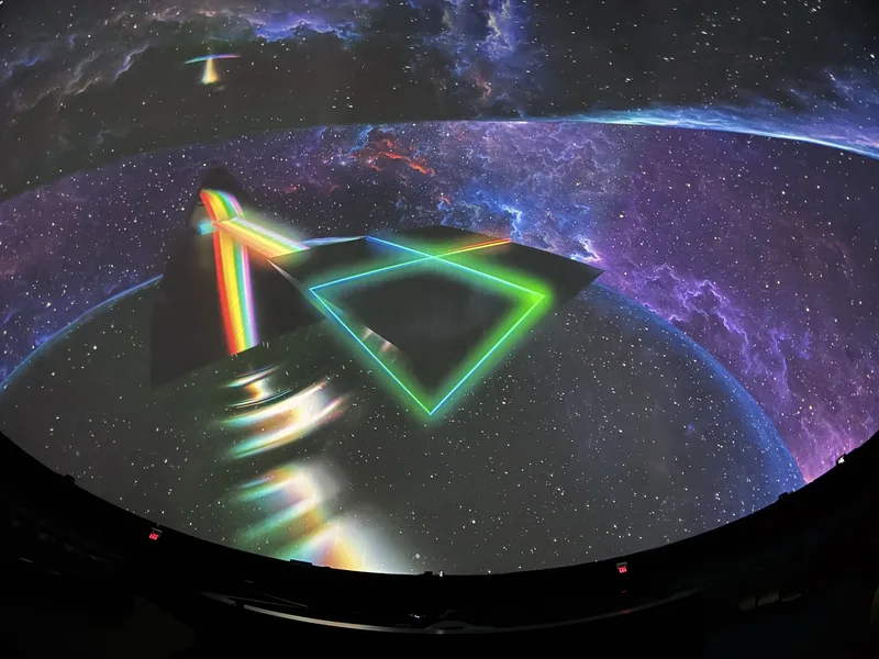 Dome theatre displaying colorful Pink Floyd projected art.