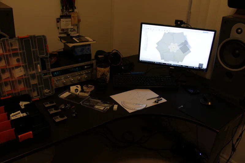 Home workbench and computer displaying prototype camera design.