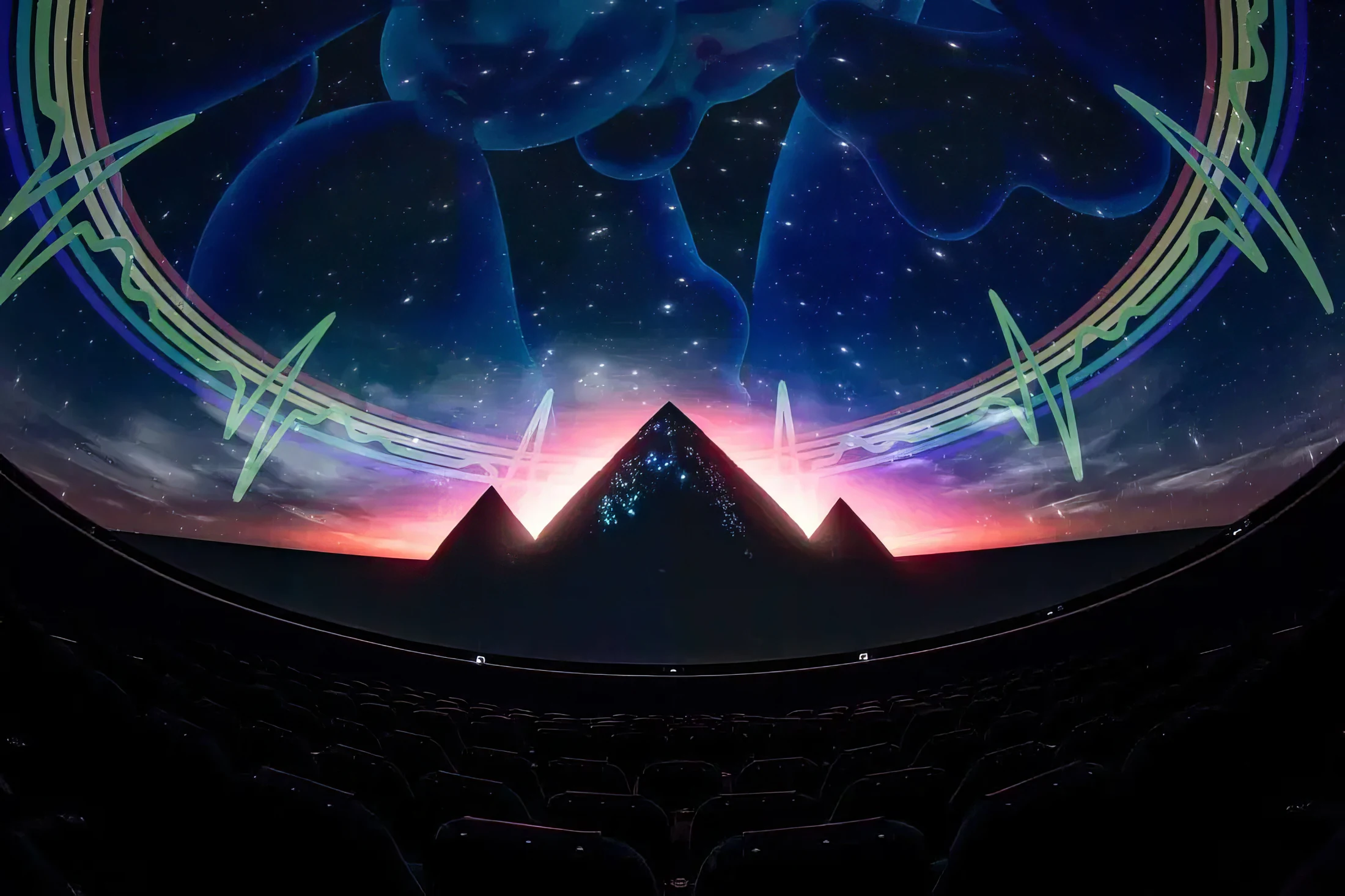Wide Dome theatre photograph with pyramids/celestial Pink Floyd projection and seats.